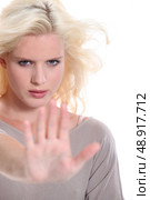 Woman holding out her hand in a stop signal. Стоковое фото, агентство Ingram Publishing / Фотобанк Лори