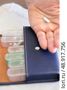 Old lady organizing her medication for the week. Стоковое фото, агентство Ingram Publishing / Фотобанк Лори