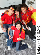 A group of friends supporting the Spanish football team. Стоковое фото, агентство Ingram Publishing / Фотобанк Лори