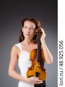 Woman artist with violin in music concept. Стоковое фото, агентство Ingram Publishing / Фотобанк Лори