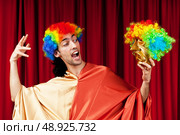 Actor with maks in a funny theater concept. Стоковое фото, агентство Ingram Publishing / Фотобанк Лори