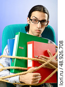 Young businessman tied with rope. Стоковое фото, агентство Ingram Publishing / Фотобанк Лори