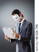 Industrial espionate concept with masked businessman. Стоковое фото, агентство Ingram Publishing / Фотобанк Лори