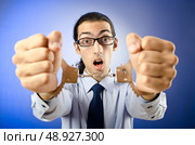 Businessman handcuffed in studio shooting. Стоковое фото, агентство Ingram Publishing / Фотобанк Лори