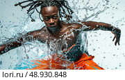 A man with dreadlocks dives into a pool of water, creating a dramatic splash. Стоковое AI-изображение, AI-художник Данила Большаков / Фотобанк Лори