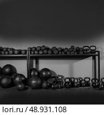 Kettlebells dumbbells and weighted slam balls weight training equipment at gym. Стоковое фото, агентство Ingram Publishing / Фотобанк Лори