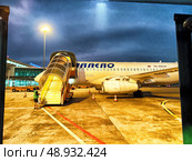 Phu Quoc, Vietnam - April 05, 2025: Evening departure at Phu Quoc Island Airport with jet bridge in view. Редакционное фото, фотограф Кривошеина Елена Леонидовна / Фотобанк Лори