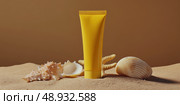 Yellow Sunscreen cream tube, starfishes and seashells on a sand top view. Cosmetic mockup. Sunblock lotion on sandy beach background. Summer vacation care concept, sun screen product, spf uv protect. Стоковое AI-изображение, AI-художник Марина Демидюк / Фотобанк Лори