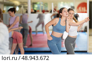 Female pupil clash with training manager during self-defense lesson, repulse charge, intensity of practice. Стоковое фото, фотограф Яков Филимонов / Фотобанк Лори