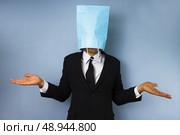 Businessman with bag over head is confused . Стоковое фото, агентство Ingram Publishing / Фотобанк Лори
