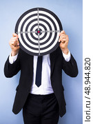 Businessman with a dart board in front of his face. Стоковое фото, агентство Ingram Publishing / Фотобанк Лори