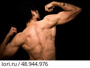 Athletic young man flexing his muscles. Стоковое фото, агентство Ingram Publishing / Фотобанк Лори