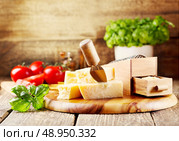 parmesan cheese with grater on wooden background. Стоковое фото, агентство Ingram Publishing / Фотобанк Лори