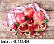 fresh pomegranates on wooden board. Стоковое фото, агентство Ingram Publishing / Фотобанк Лори