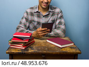 Man with books and tablet is reading. Стоковое фото, агентство Ingram Publishing / Фотобанк Лори