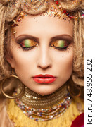 young woman with fashion makeup and closed eyes on brown background. Стоковое фото, агентство Ingram Publishing / Фотобанк Лори