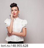Vintage model posing in white shirt on grey background. Стоковое фото, агентство Ingram Publishing / Фотобанк Лори