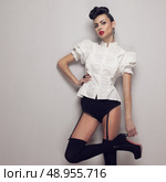 Sexy trendy model posing in vintage shirt, black lingerie, high heels. Стоковое фото, агентство Ingram Publishing / Фотобанк Лори