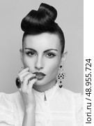 Close Up of vintage styling model with makeup and updo. accessories. Red lips. White lacy shirt. Стоковое фото, агентство Ingram Publishing / Фотобанк Лори