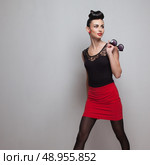 Business styling walking model in red short skirt and black shirt. Стоковое фото, агентство Ingram Publishing / Фотобанк Лори