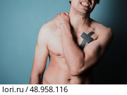 Young man is in pain and is massasing his sore neck. Стоковое фото, агентство Ingram Publishing / Фотобанк Лори