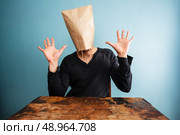 Man with paper bag over his head is shocked. Стоковое фото, агентство Ingram Publishing / Фотобанк Лори