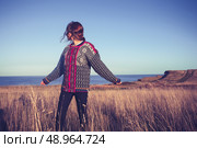 Young woman dancing and spinning around in a field at sunset. Стоковое фото, агентство Ingram Publishing / Фотобанк Лори