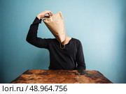 Man with paper bag over his head is confused. Стоковое фото, агентство Ingram Publishing / Фотобанк Лори