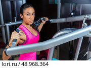 Lat Lateral dorsal pulldown machine upper back exercises woman at gym workout. Стоковое фото, агентство Ingram Publishing / Фотобанк Лори