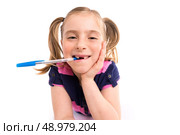 Blond kid indented girl student with spiral notebook in pupil desk. Стоковое фото, агентство Ingram Publishing / Фотобанк Лори