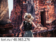 A young woman is exploring the ancient ruins of a buddhist temple city. Стоковое фото, агентство Ingram Publishing / Фотобанк Лори