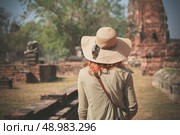 A young woman is exploring the ancient ruins of a buddhist temple city. Стоковое фото, агентство Ingram Publishing / Фотобанк Лори