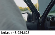 Due to technical malfunction, driver was forced to pull over. he took fire extinguisher from cabin and began to eliminate fire that was taking place under hood of smoking car. Стоковое видео, видеограф Strunov David / Фотобанк Лори