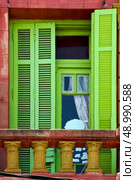 light green wood venetian blind and a red terrace  wall in la boca buenos aires argentina. Стоковое фото, агентство Ingram Publishing / Фотобанк Лори
