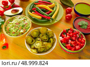 Mexican food mixed guacamole nachos chili sauce dipping cheddar cheese lemon pico de gallo. Стоковое фото, агентство Ingram Publishing / Фотобанк Лори