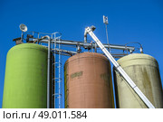 Industrial silos isolated on blue background at a farming industry. Стоковое фото, агентство Ingram Publishing / Фотобанк Лори