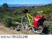 cycling tourism MTB bike in Pedralba Villamarxant Valencia with panniers and saddlebag. Стоковое фото, агентство Ingram Publishing / Фотобанк Лори