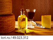 Manchego cheese from Spain with olive oil and red wine on wood. Стоковое фото, агентство Ingram Publishing / Фотобанк Лори