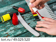 varnish for nail polish. Tubes with varnish for nail polish of different colors on an old wooden background. Стоковое фото, агентство Ingram Publishing / Фотобанк Лори