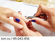 Cuticle nippers tool in nails salon woman hands treatment. Стоковое фото, агентство Ingram Publishing / Фотобанк Лори