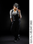 Young girl in manly style with cigar on black. Стоковое фото, агентство Ingram Publishing / Фотобанк Лори