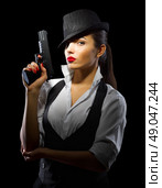 Portrait of young woman in manly style with gun isolated. Стоковое фото, агентство Ingram Publishing / Фотобанк Лори