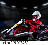 Young girl karting racer at stadium. Стоковое фото, агентство Ingram Publishing / Фотобанк Лори