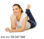 Young girl laying on the floor isolated. Стоковое фото, агентство Ingram Publishing / Фотобанк Лори