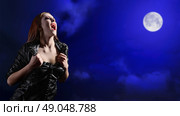 Vampire girl on night sky background. Стоковое фото, агентство Ingram Publishing / Фотобанк Лори