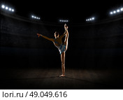 Young girl engaged art gymnastic at sports hall. Стоковое фото, агентство Ingram Publishing / Фотобанк Лори