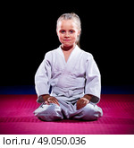 Little girl aikido fighter on black. Стоковое фото, агентство Ingram Publishing / Фотобанк Лори