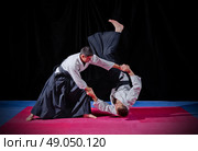 Fight between two aikido fighters on black. Стоковое фото, агентство Ingram Publishing / Фотобанк Лори