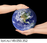 Child and woman holds earth globe on black. Стоковое фото, агентство Ingram Publishing / Фотобанк Лори