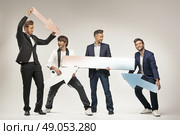 Amused guys holding arrows and boards. Стоковое фото, агентство Ingram Publishing / Фотобанк Лори